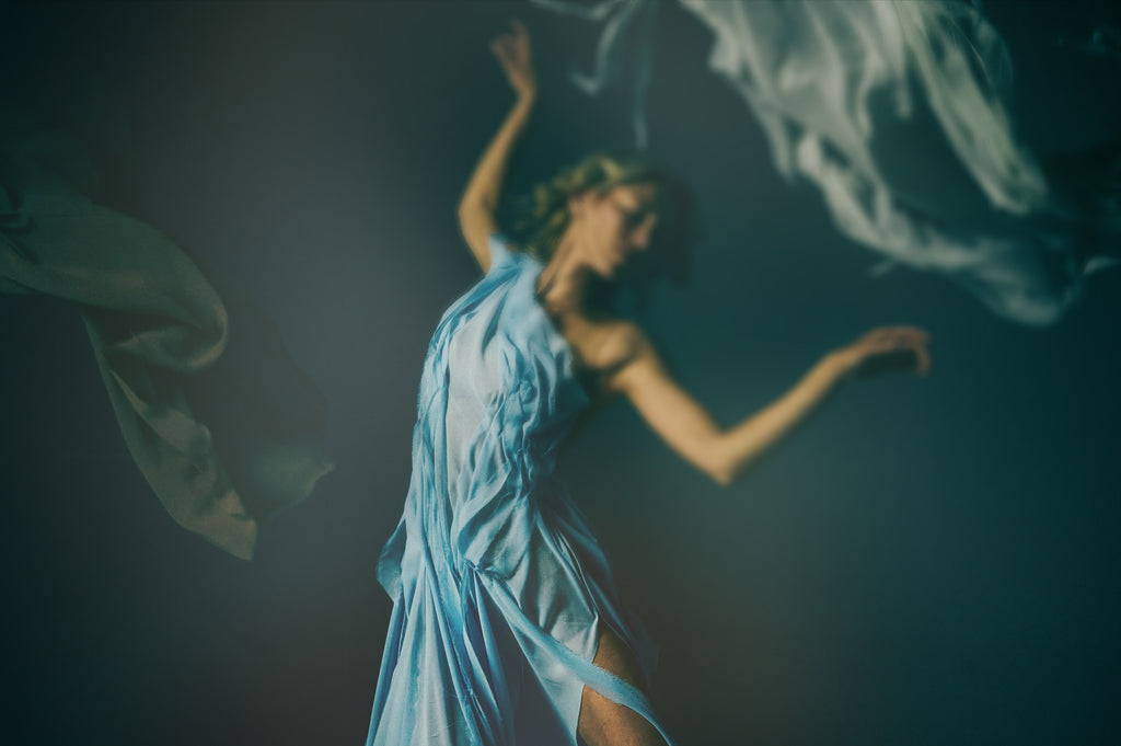 lucid dream perfume bottle by Reinvented Parfums, niche fragrance saffron rose oud, luxury unisex perfume flatlay, dreamy surreal perfume imagery