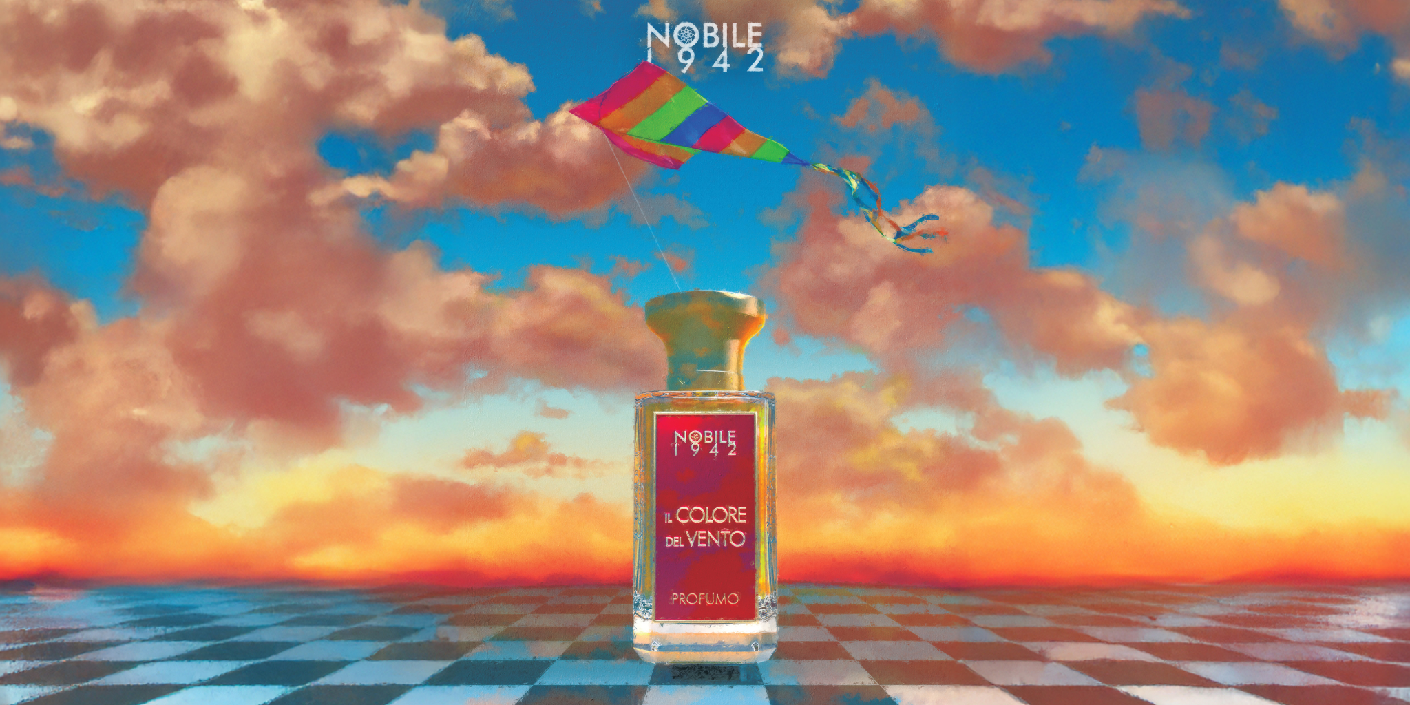 A perfume bottle labeled Nobile 1942 stands on a checkered surface under a vibrant sky with colorful clouds and a rainbow kite flying above.